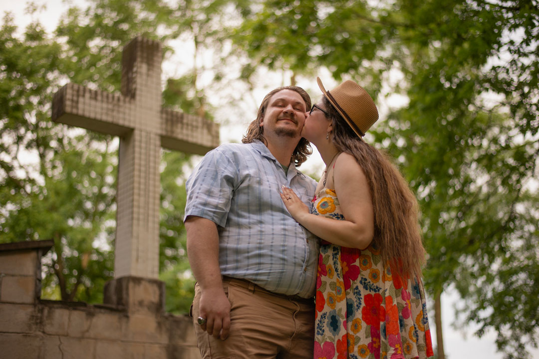 Snader & Emily Engagement Shoot Kissing by the Cross