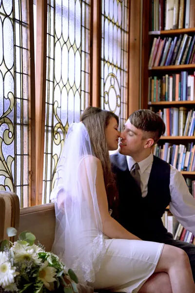 Wedding Photo by Stain Glass Window Bench Kiss